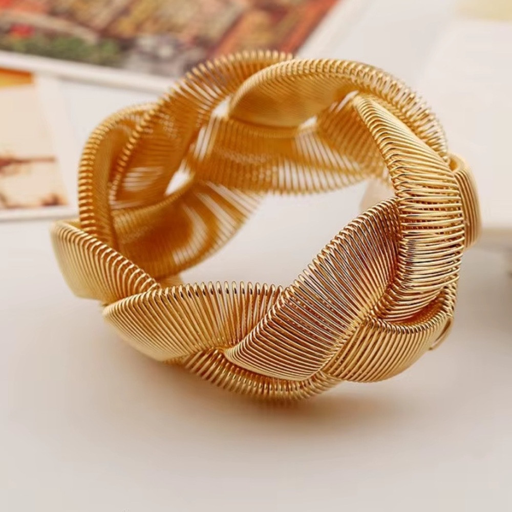 The Sophie bracelet is a braided gold bangle by Plunder Design